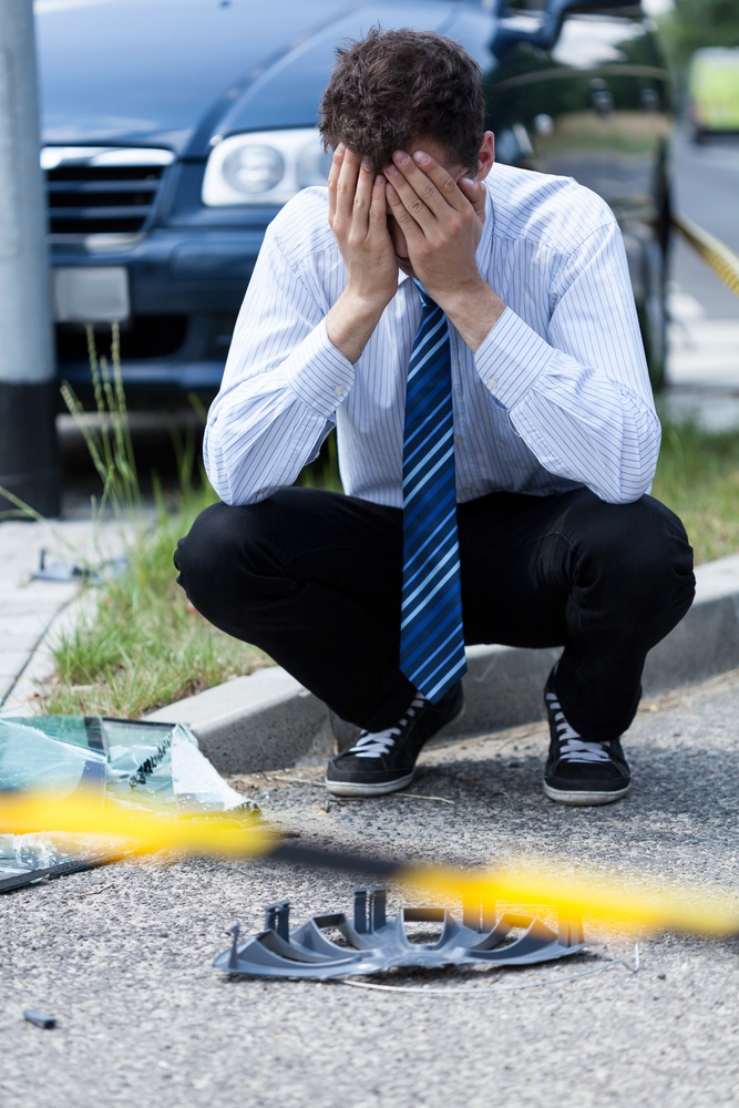 Elegant man crying at accident scene, vertical.jpeg