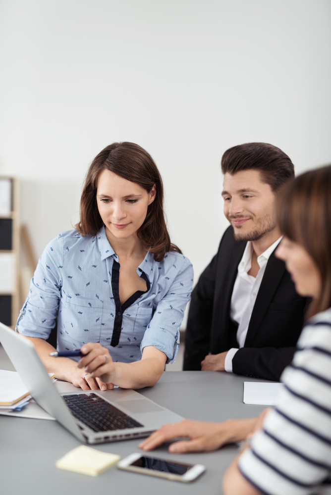 Young Professional People Using a Laptop Computer for Presentation While Having a Business Meeting Inside the Office.