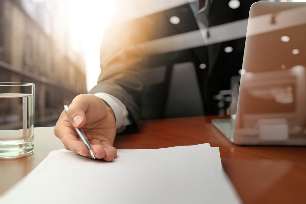 double exposure of businessman or salesman handing over a contract on wooden desk.jpeg